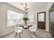 Cozy dining area with modern lighting, white table set, and ample natural light at 119 N Smallwood Pl, Charlotte, NC 28216