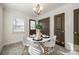 Cozy dining area with modern light fixture, white table and hardwood floors at 119 N Smallwood Pl, Charlotte, NC 28216