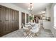 Dining area with modern light fixture, white table, hardwood floors and view of the kitchen at 119 N Smallwood Pl, Charlotte, NC 28216