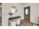 Inviting entryway featuring wood floors, decorative mirror and table with seating at 119 N Smallwood Pl, Charlotte, NC 28216