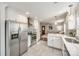 Open kitchen with stainless steel appliances, white cabinets, and hardwood floors at 119 N Smallwood Pl, Charlotte, NC 28216