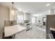 Modern white kitchen with stainless appliances, quartz countertops, and stylish backsplash at 119 N Smallwood Pl, Charlotte, NC 28216