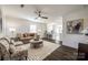Bright living room with hardwood floors and neutral decor flows to the kitchen at 119 N Smallwood Pl, Charlotte, NC 28216