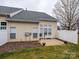 Backyard patio area featuring a white bench, privacy fence, and manicured lawn at 120 Snead Rd, Fort Mill, SC 29715
