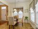 Dining area featuring a glass table, four chairs, and window overlooking front yard at 120 Snead Rd, Fort Mill, SC 29715