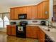 Functional kitchen featuring wood cabinets, black appliances, and ample counter space at 120 Snead Rd, Fort Mill, SC 29715