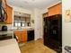 Kitchen with wood cabinets, black appliances, and a view into the dining area at 120 Snead Rd, Fort Mill, SC 29715