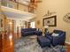 Open concept living space with wood floors, a cozy sofa, and second floor view at 120 Snead Rd, Fort Mill, SC 29715