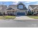 Inviting two-story home featuring a well-maintained lawn and a spacious driveway at 1284 Independence St, Tega Cay, SC 29708