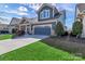 Beautiful two-story home with a well-kept lawn and attached two car garage at 1284 Independence St, Tega Cay, SC 29708