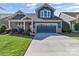 Charming two-story home with a manicured lawn and a two-car garage on a sunny day at 1284 Independence St, Tega Cay, SC 29708
