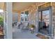 Inviting front porch with stone accents and cozy seating arrangement at 1284 Independence St, Tega Cay, SC 29708