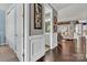 Hallway with hardwood floors, white trim, and view into adjacent rooms at 1284 Independence St, Tega Cay, SC 29708