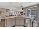 Open-concept kitchen island with granite countertops, seating, and stainless steel appliances at 1284 Independence St, Tega Cay, SC 29708
