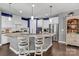 A modern kitchen boasting granite countertops, stainless steel appliances, and a breakfast bar with stylish pendant lighting at 1284 Independence St, Tega Cay, SC 29708