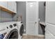 A gray laundry room features front loading washer and dryer, with white cabinetry at 1284 Independence St, Tega Cay, SC 29708