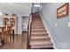 This staircase features carpet, hardwood flooring, and gray walls at 1284 Independence St, Tega Cay, SC 29708