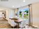 Bright dining area featuring a large window with backyard view and modern white chairs at 130 Mountain Bridge Way, Statesville, NC 28625