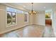 Bright dining room featuring large windows with beautiful backyard pond views at 13019 Westmoreland Farm Rd, Davidson, NC 28036