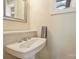 Cozy half bath with a pedestal sink and a framed mirror, offering functionality and style at 13019 Westmoreland Farm Rd, Davidson, NC 28036