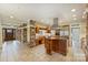 Open-concept kitchen with stone pillars, granite countertops, stainless steel appliances, and custom cabinets at 13019 Westmoreland Farm Rd, Davidson, NC 28036