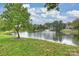 Picturesque pond with a fountain feature, lush greenery, and a view of surrounding homes at 13019 Westmoreland Farm Rd, Davidson, NC 28036