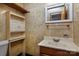 This bathroom is complete with a toilet, sink with cabinet, and storage space above the toilet at 132 Kennedy Ave, Kannapolis, NC 28083