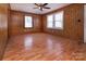 This bedroom is complete with hardwood flooring, a ceiling fan, and two windows for natural light at 132 Kennedy Ave, Kannapolis, NC 28083
