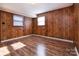 This bedroom is complete with hardwood flooring and two windows for natural light at 132 Kennedy Ave, Kannapolis, NC 28083