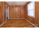 This bedroom is complete with hardwood flooring and a door leading to another room at 132 Kennedy Ave, Kannapolis, NC 28083