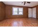 This bedroom is complete with hardwood flooring, a ceiling fan, and two windows for natural light at 132 Kennedy Ave, Kannapolis, NC 28083