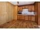 Functional kitchen showcasing wood cabinets, laminate countertops, and vinyl flooring at 132 Kennedy Ave, Kannapolis, NC 28083