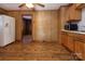 Functional kitchen showcasing wood cabinets, modern appliances, and vinyl flooring at 132 Kennedy Ave, Kannapolis, NC 28083