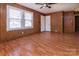 Inviting living room with wood paneling, a ceiling fan, and hardwood floors, perfect for entertaining or relaxing at 132 Kennedy Ave, Kannapolis, NC 28083