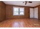 Inviting living room showcasing wood-look floors, wood paneling, and a well-lit space with a ceiling fan at 132 Kennedy Ave, Kannapolis, NC 28083