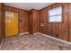 Functional rear entry with wood paneled walls, tile flooring, and exterior door access at 132 Kennedy Ave, Kannapolis, NC 28083