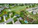 An aerial view of a home next to #1 Green on a golf course, with mature trees and a nearby community pool at 137 Tenth Green Ct, Statesville, NC 28677