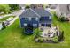 Expansive backyard featuring a stone patio, fire pit, outdoor seating, and a trampoline, perfect for entertaining and recreation at 137 Tenth Green Ct, Statesville, NC 28677
