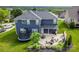 Beautiful backyard with a spacious patio, an outdoor dining area, trampoline and a well-manicured lawn at 137 Tenth Green Ct, Statesville, NC 28677