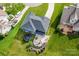Aerial view of the backyard with a patio, a firepit, and trampoline surrounded by a well-maintained lawn at 137 Tenth Green Ct, Statesville, NC 28677