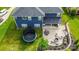 Aerial view of the backyard with a large patio, a dining table, and trampoline on a manicured lawn at 137 Tenth Green Ct, Statesville, NC 28677