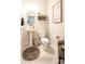 Clean half bathroom with pedestal sink, round mirror, and decorative wall decor at 137 Tenth Green Ct, Statesville, NC 28677