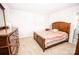 Comfortable bedroom featuring a wooden dresser, a full-size bed, and neutral, light carpet at 137 Tenth Green Ct, Statesville, NC 28677