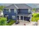 Back exterior of a two-story blue house, featuring a large backyard with a trampoline, patio and outdoor seating at 137 Tenth Green Ct, Statesville, NC 28677