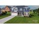 Charming two-story home with brick and siding, attached two-car garage and well-maintained lawn at 137 Tenth Green Ct, Statesville, NC 28677