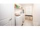 Practical laundry room with washer, dryer, shelving, and a window at 137 Tenth Green Ct, Statesville, NC 28677