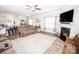 Spacious living room with fireplace, ceiling fan, and open layout to the kitchen at 137 Tenth Green Ct, Statesville, NC 28677
