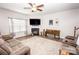 Spacious living room with a fireplace, ceiling fan, and lots of natural light at 137 Tenth Green Ct, Statesville, NC 28677