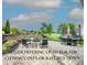 Outdoor patio with a fire pit, seating, dining area, trampoline, and manicured landscaping offers relaxation and entertainment at 137 Tenth Green Ct, Statesville, NC 28677