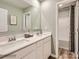 Bright bathroom featuring double vanity with white countertop, wood-look floors, and a shower-tub combo at 143 Mountain Bridge Way, Statesville, NC 28625